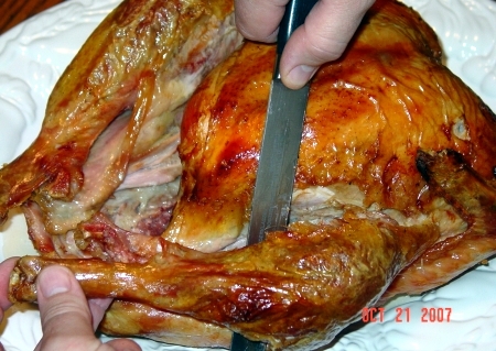 Cut into the joint, between the drumstick and the thigh