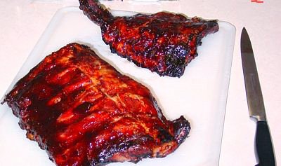 Ribs just out of the oven. Spareribs prepared without a rub, cooked with sauce on. Ribs just out of the oven. Spareribs prepared without a rub, cooked with sauce on.